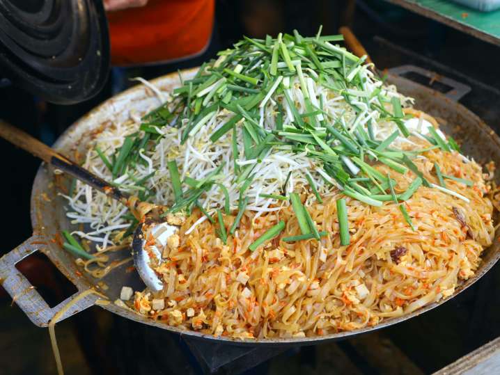 chef cooking pad thai in large skillet | Classpop Shot