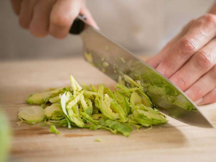 chef slicing brussels sprouts for a salad | Classpop Shot