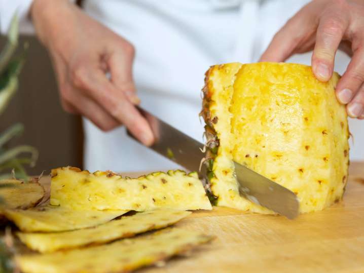 chef slicing fresh pineapple | Classpop Shot