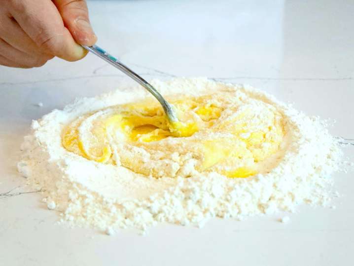 chef mixing flour and eggs to make pasta dough | Classpop Shot