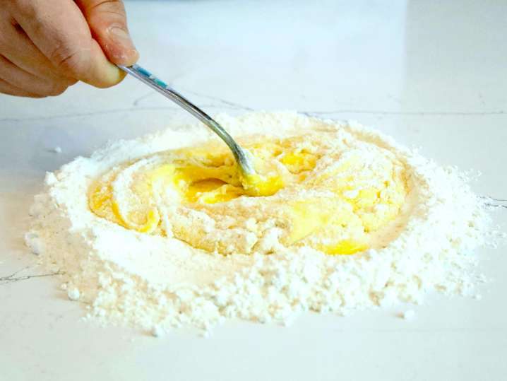 chef mixing flour and eggs to make pasta dough | Classpop Shot