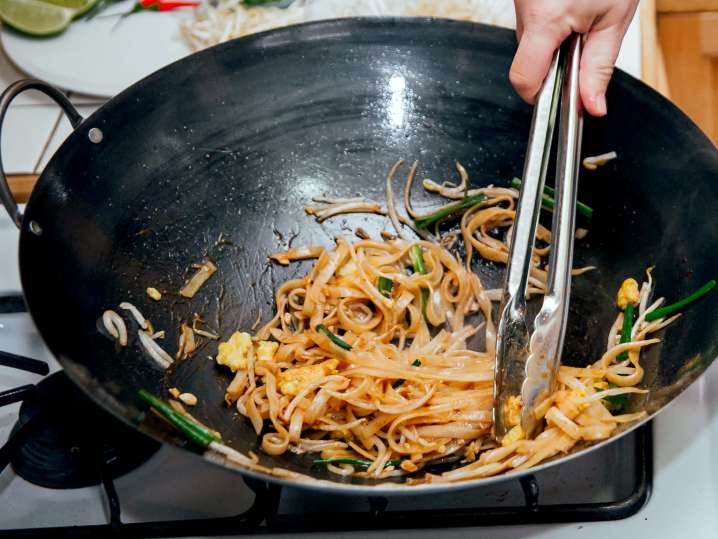 stirring pad thai in a pan | Classpop Shot