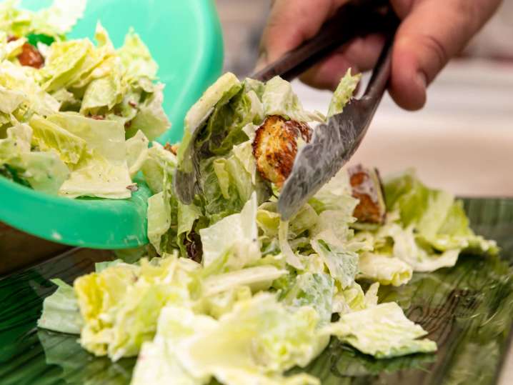 Chef plating fresh caesar salad | Classpop Shot