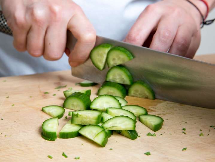 Chef slicing fresh cucumber | Classpop Shot