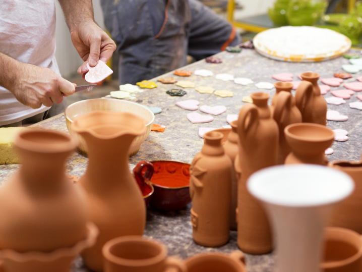 San Diego - people molding clay on outdoor table Shot