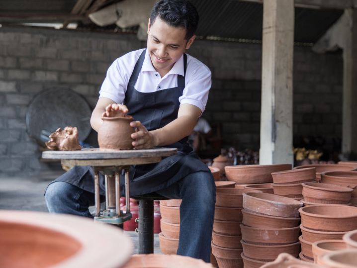 San Diego - man molding clay on pottery wheel outdoors Shot