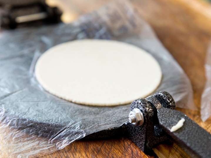 masa dough getting pressed into tortilla | Classpop Shot