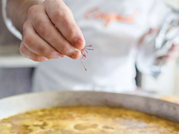 chef adding saffron to paella while cooking | Classpop Shot