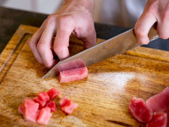 person slicing tuna for sushi rolls | Classpop Shot