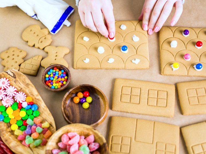 person assembling and decorating gingerbread house | Classpop Shot