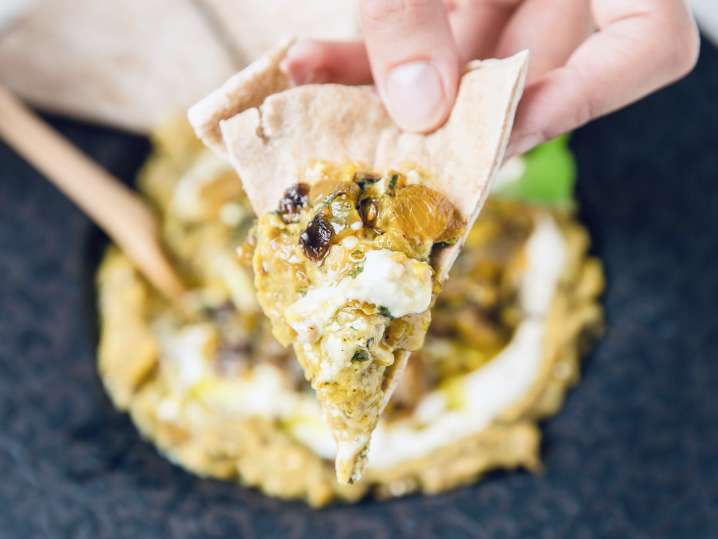 chef presenting baba ganoush on pita bread | Classpop Shot