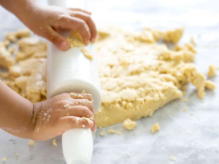 a kid rolling out shortbread cookie dough | Classpop Shot