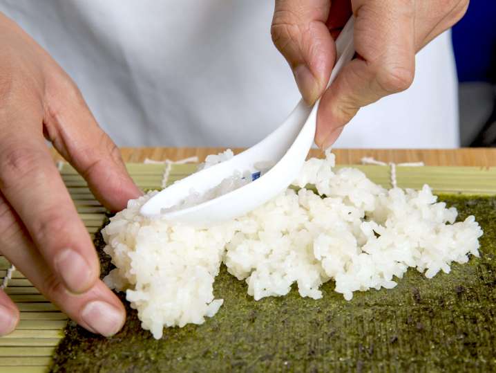 chef adding sushi rice to nori | Classpop Shot