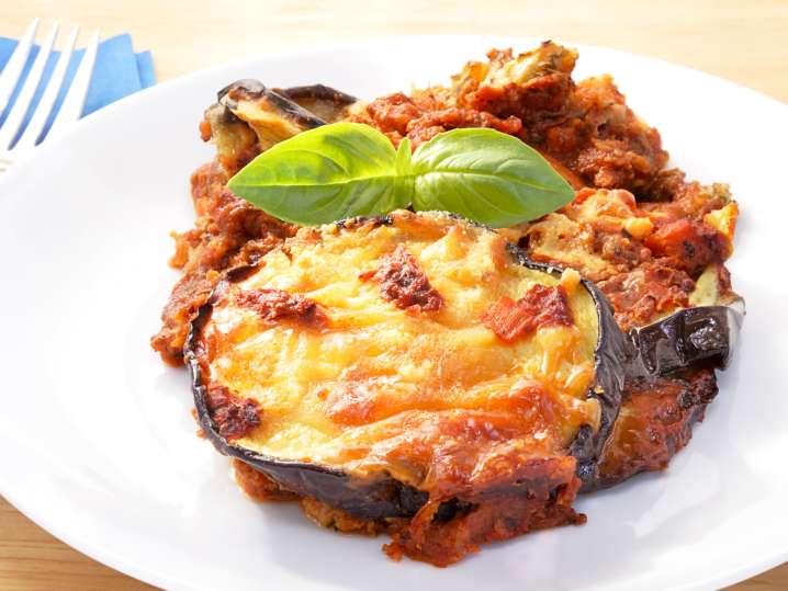 eggplant parmesan on a white flat with a fork | Classpop Shot