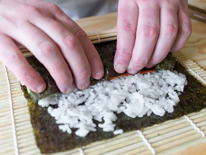 a person making maki sushi rolls | Classpop Shot