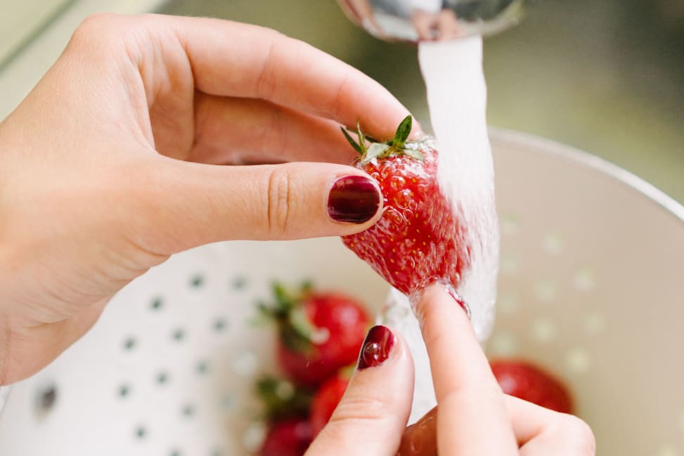 Los Angeles - Unrecognizable woman washing strawberry in kitchen Shot 1
