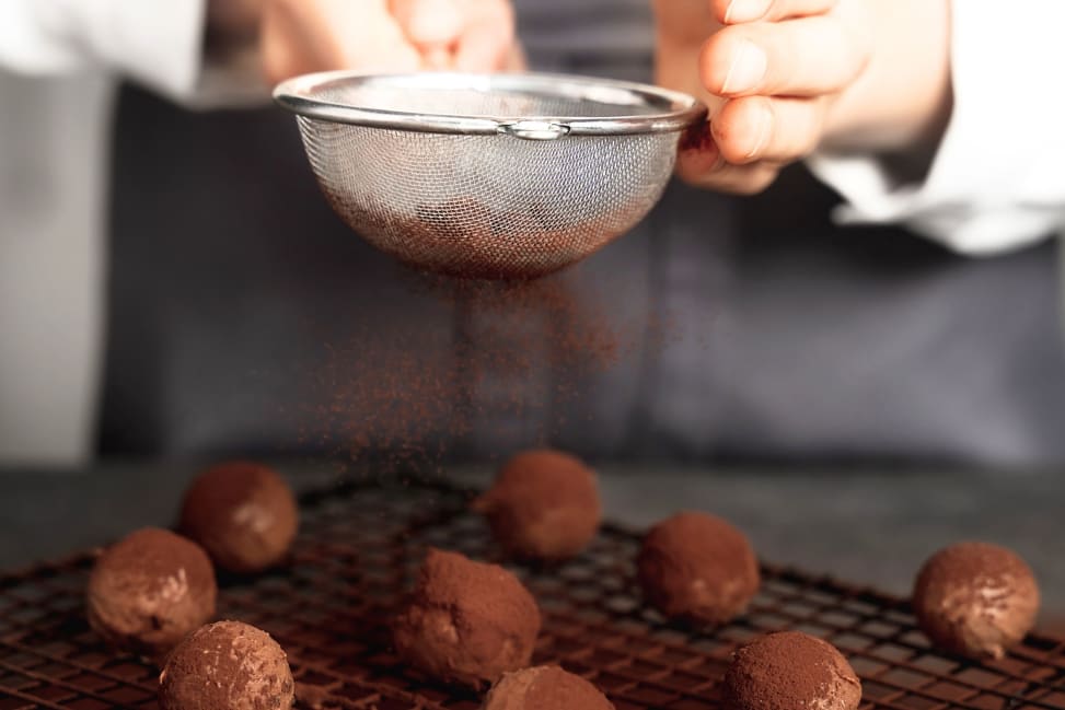 Atlanta - dusting cacao over chocolate truffles Shot 3