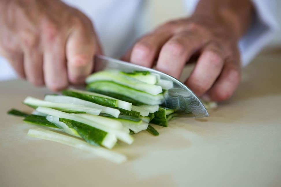 Los Angeles - Chopping fresh cucumber into thin strips for sushi Shot 4