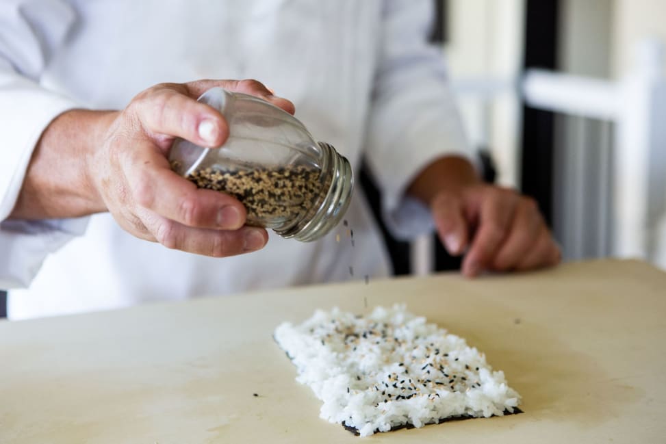 Chicago - Chef sprinkling sesame seeds on freshly prepared sushi rice Shot 3