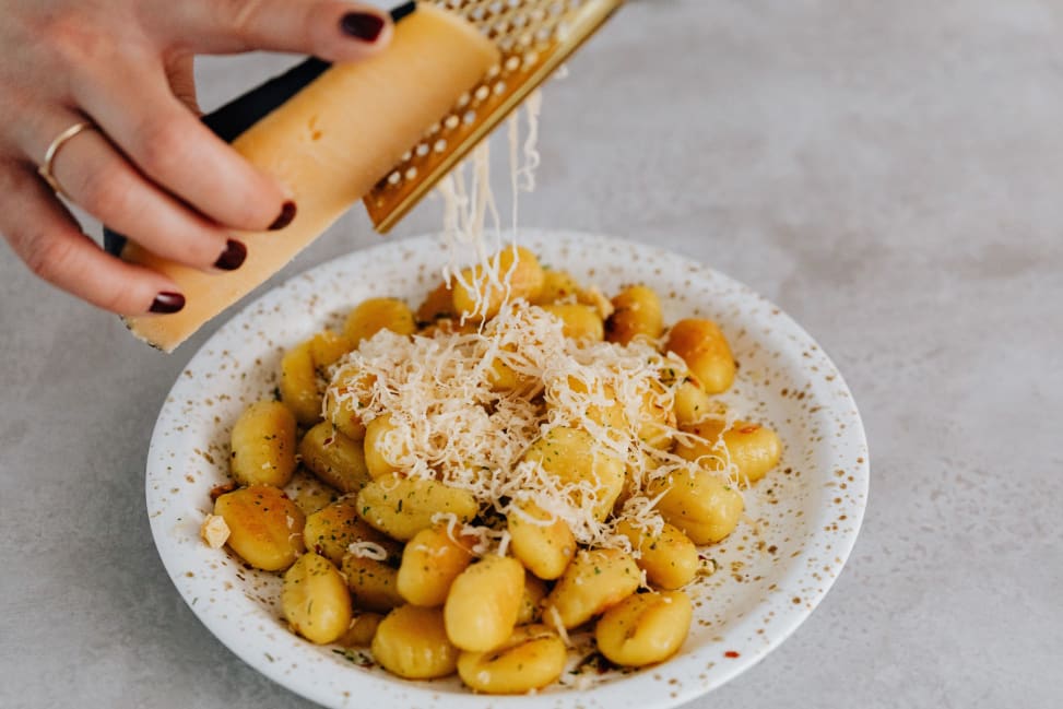 grating cheese over gnocchi | Classpop Shot 2