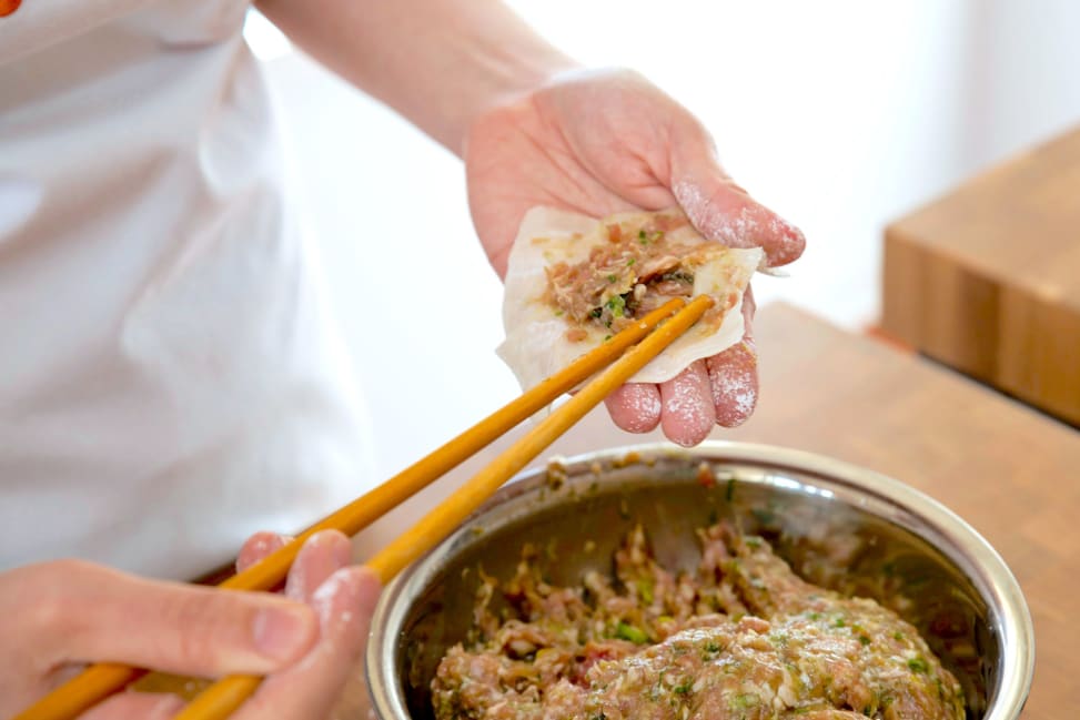 Filling dumpling wrapper with pork mixture | Classpop Shot 2