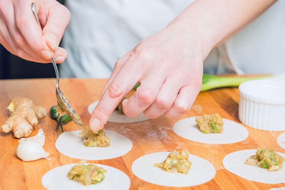 Filling momo wrappers with ginger garlic chicken for Nepalese steamed momos | Classpop Shot 2