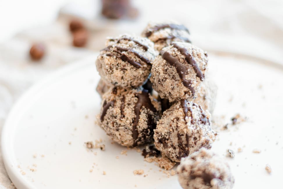 a stack of chocolate truffles with chocolate drizzle on a plate Shot 2