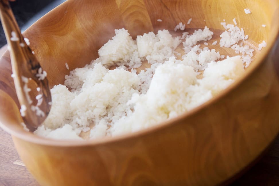 stirring sushi rice in a wooden bowl Shot 1