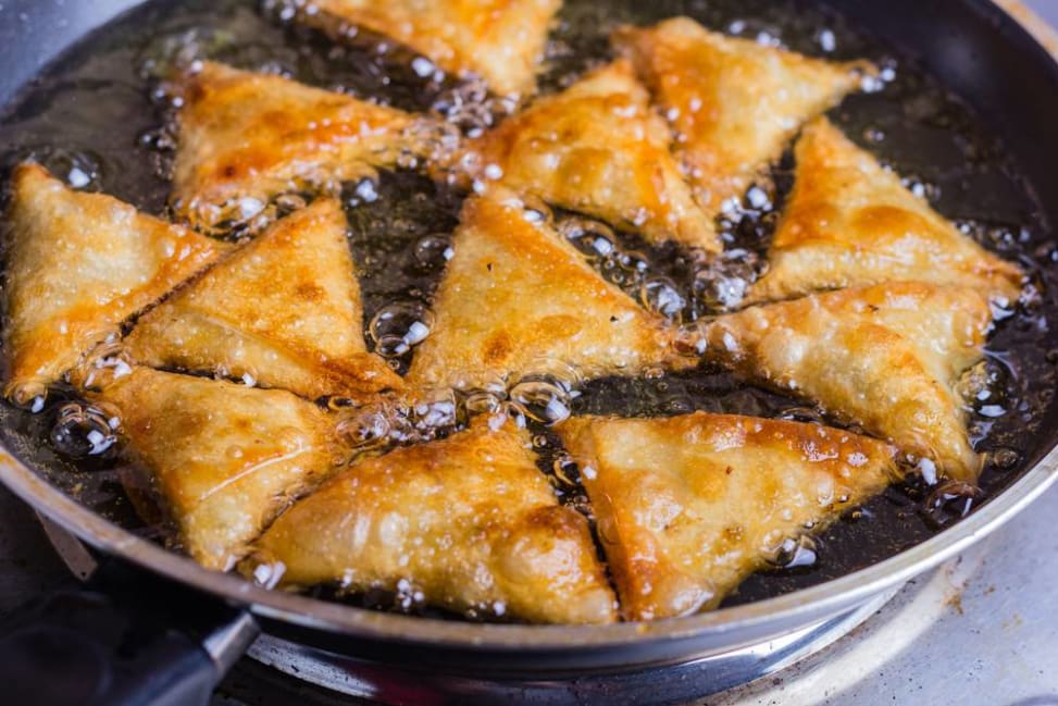 aloo samosas frying in hot oil Shot 3