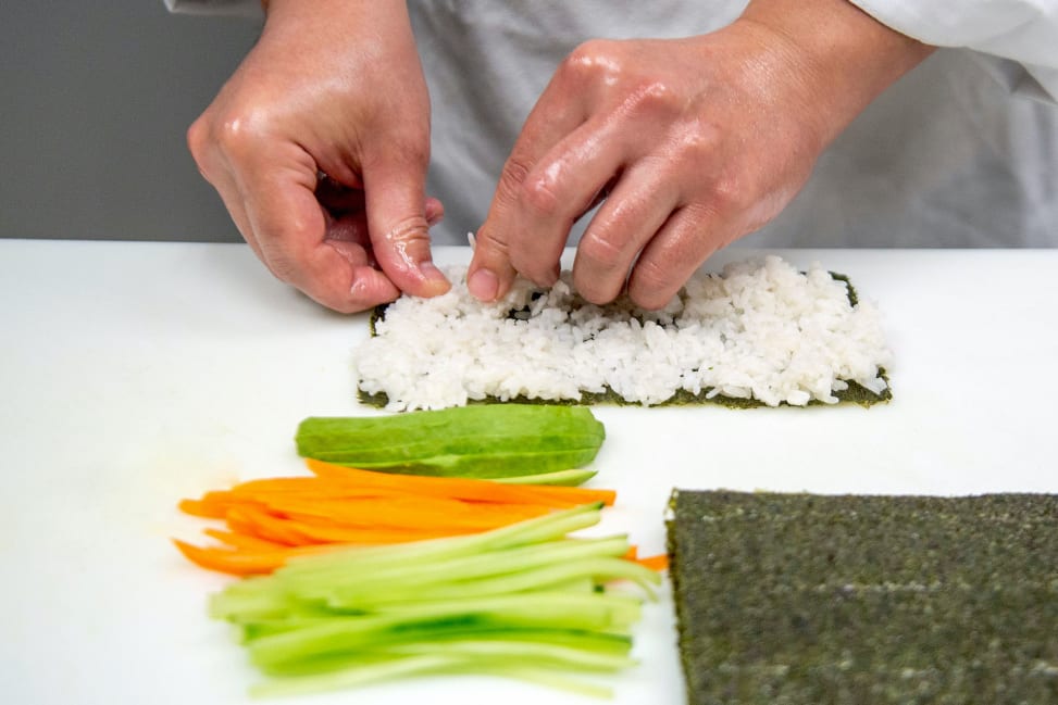 chef's hands preparing a sushi roll Shot 1