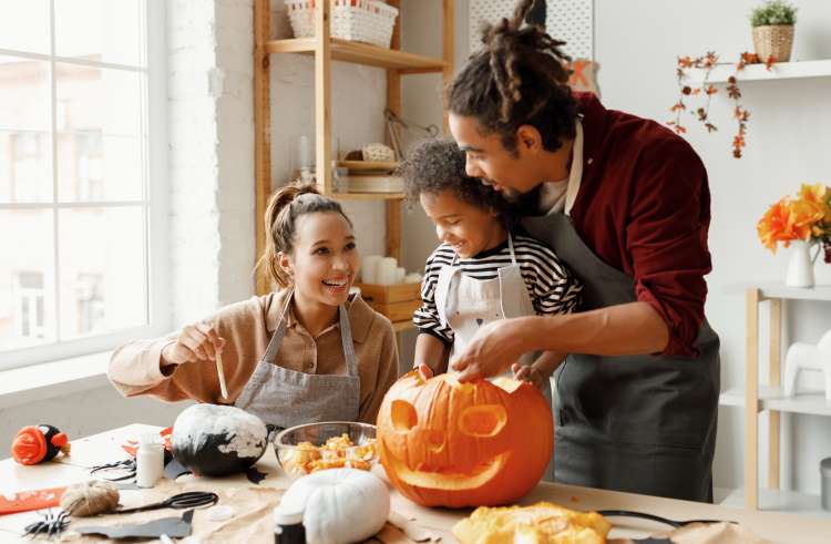 Carved Pumpkins, Smiling, on a Table Out of Doors Facing and Side