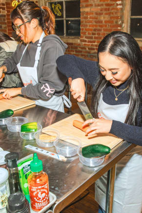 Friends prepping ingredients during a girls night out cooking class