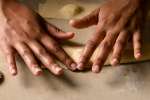 chef hands working with fresh sheet of pasta dough Shot