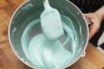 blue macaron batter in a mixing bowl Shot