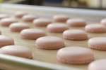 pink macarons on a baking sheet Shot