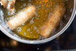 eggrolls frying in hot oil Shot