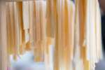 linguine hanging on a pasta rack Shot
