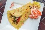 savory crepes on a plate with vegetables
