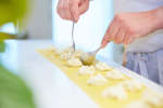 spooning ricotta filling into ravioli Shot