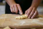 chef cutting fresh pasta dough into ribbons Shot