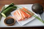 chef's knife, fresh tuna, and scallions on a cutting board Shot