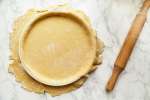 pie dough rolled out and placed over a pan Shot