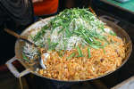 Phoenix - chef cooking pad thai in large skillet Shot