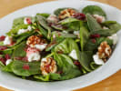 Cooking Class - French Foodie Fun in South Bay & Peninsula: Fresh spinach salad topped with candied walnuts, dried cranberries, and creamy dressing, served in a white bowl.