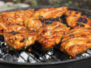 Cooking Class - Latin Foodie Focus in Northern Suburbs: Grilled Peruvian spice-rubbed chicken thighs with charred edges, sizzling on the grill.