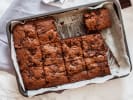 Cooking Class - Fall Flavors, Baked to Perfection in Downtown Dallas: Freshly baked chocolate-cranberry brownies sliced in a parchment-lined pan.