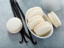 Cooking Class - Icons of French Baking in South Bay & Peninsula: White bowl of vanilla macarons with whole vanilla beans on a gray background.