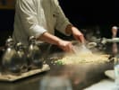 Hibachi Catering - Fire of the Hibachi Feast: cheff preparing a dish on grill