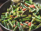 Cooking Class - Downton Style Dining in South Bay & Peninsula: Green bean side dish – Sautéed green beans with crispy bacon bits and slivers of onion, served in a large black skillet.
