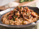 Cooking Class - Peruvian-Inspired Flavor Journey in Downtown Dallas: Hearty bowl of rice and black-eyed peas with chorizo, topped with herbs.